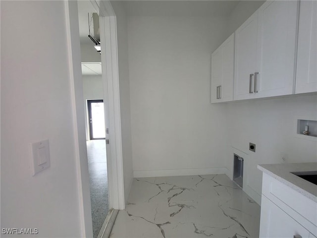 clothes washing area featuring marble finish floor, hookup for an electric dryer, washer hookup, baseboards, and cabinet space