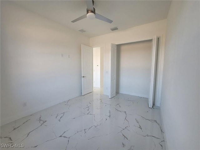 unfurnished bedroom with visible vents, ceiling fan, marble finish floor, and a closet