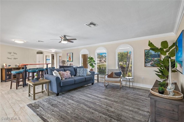 living room with ceiling fan, crown molding, and wood-type flooring