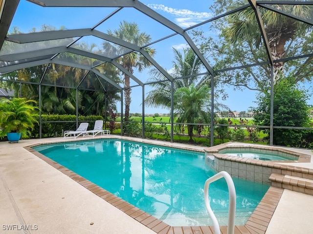 view of pool featuring an in ground hot tub, glass enclosure, and a patio