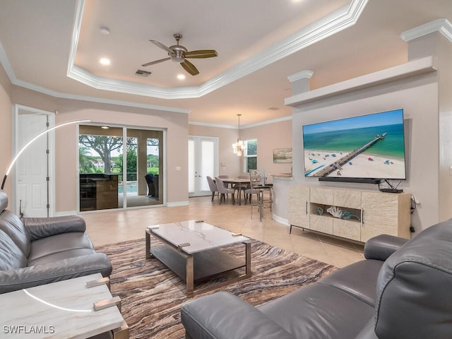 tiled living room with crown molding, a fireplace, and a tray ceiling