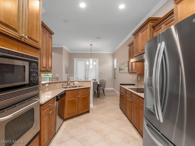 kitchen with pendant lighting, sink, crown molding, appliances with stainless steel finishes, and light stone countertops