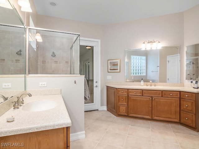 bathroom with tile patterned flooring, vanity, and a shower with shower door