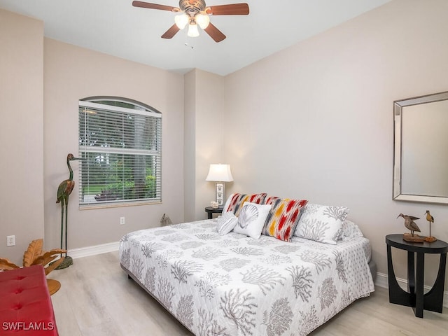 bedroom with ceiling fan and light hardwood / wood-style flooring