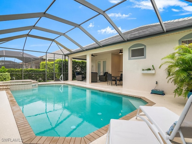 view of swimming pool featuring outdoor lounge area, an in ground hot tub, ceiling fan, glass enclosure, and a patio area