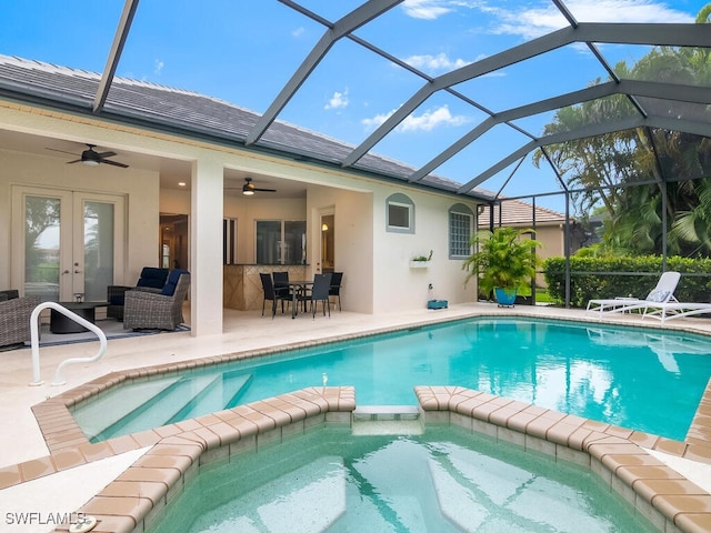 view of pool featuring a lanai, ceiling fan, a patio, an outdoor living space, and french doors