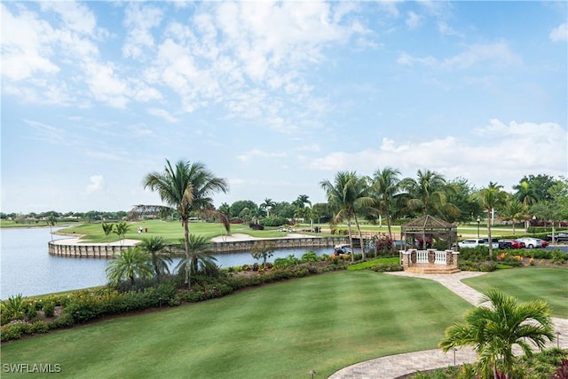 surrounding community with a yard and a water view