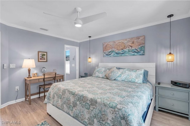 bedroom with light wood finished floors, ornamental molding, visible vents, and baseboards