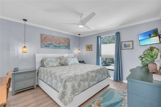 bedroom featuring light wood-style floors, crown molding, baseboards, and a ceiling fan