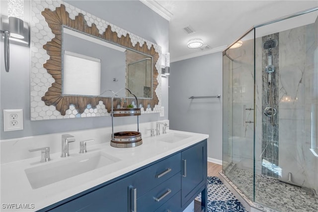 full bathroom featuring double vanity, a sink, a marble finish shower, and crown molding