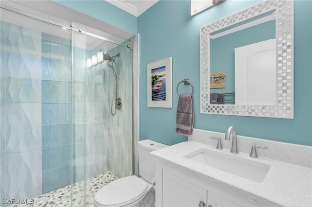 full bath with toilet, a shower stall, vanity, and crown molding