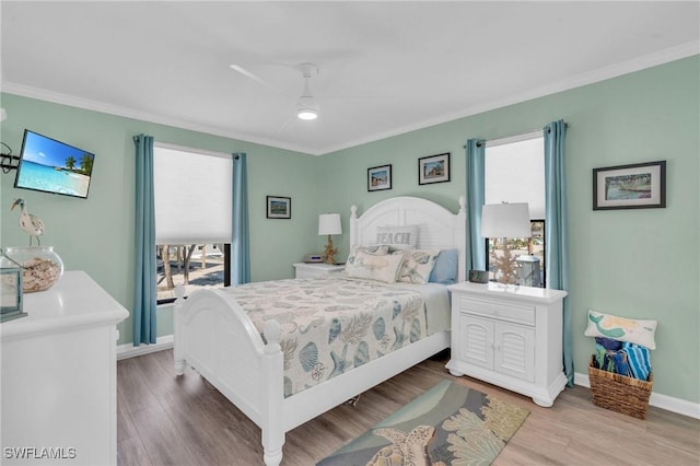 bedroom with ornamental molding, wood finished floors, and baseboards