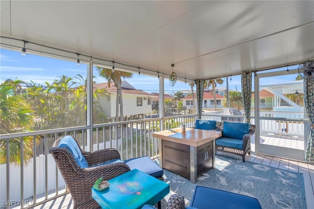 sunroom with plenty of natural light and a residential view