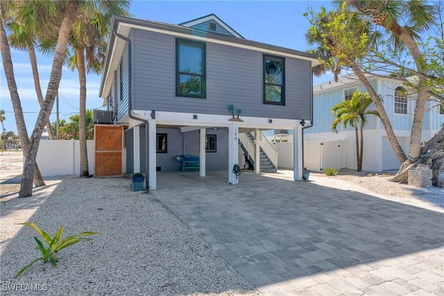 view of front of home featuring a carport and central air condition unit