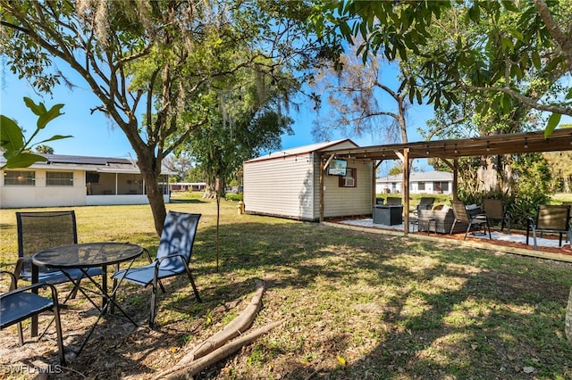 view of yard with a patio area and a storage unit