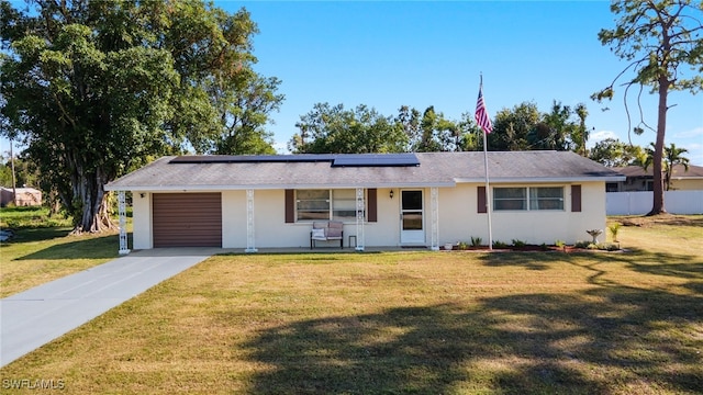 single story home featuring a garage, a porch, a front lawn, and solar panels