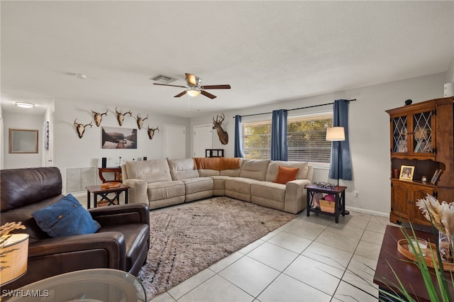 tiled living room with a textured ceiling and ceiling fan