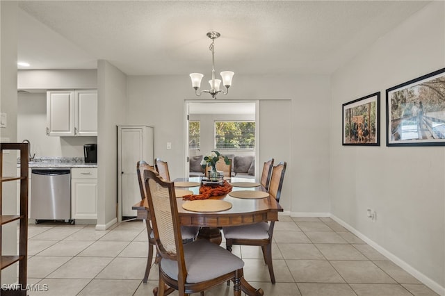 dining room with a textured ceiling, an inviting chandelier, and light tile patterned floors