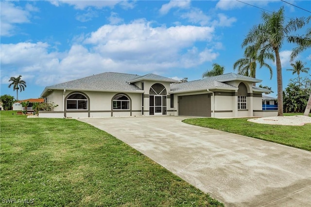 view of front of house with a front yard and a garage