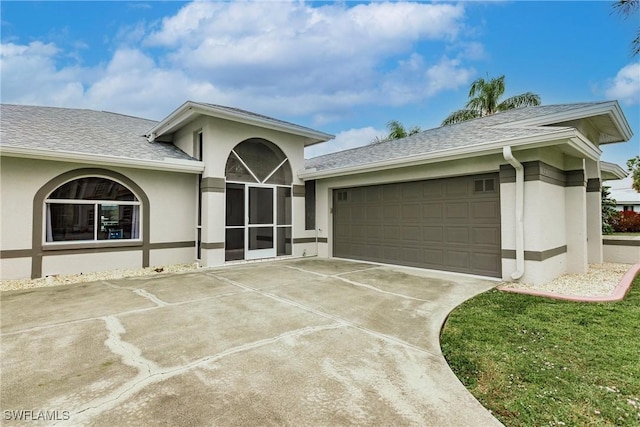 view of front facade with a front yard and a garage