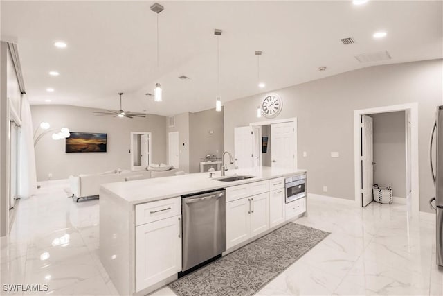 kitchen with a kitchen island with sink, appliances with stainless steel finishes, ceiling fan, white cabinets, and decorative light fixtures