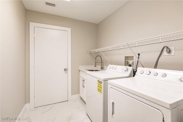 laundry area with sink, cabinets, and washer and dryer