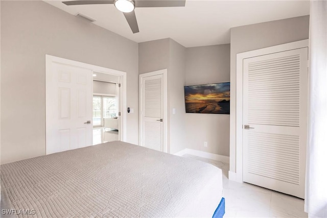 unfurnished bedroom with two closets and ceiling fan