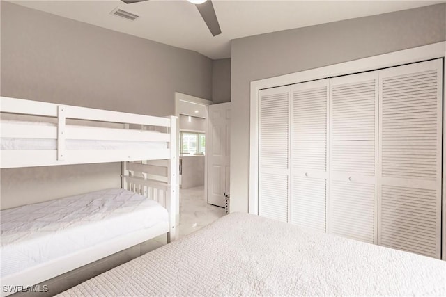 bedroom with ceiling fan and a closet