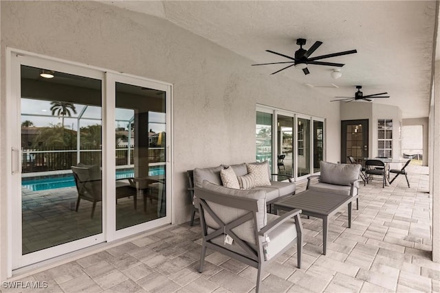 view of patio with a fenced in pool, ceiling fan, and outdoor lounge area