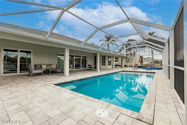 view of swimming pool featuring a lanai, a patio area, and outdoor lounge area