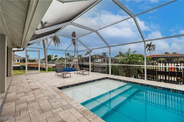 view of swimming pool with a lanai and a patio area