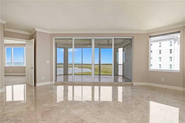 empty room featuring ornamental molding and a healthy amount of sunlight