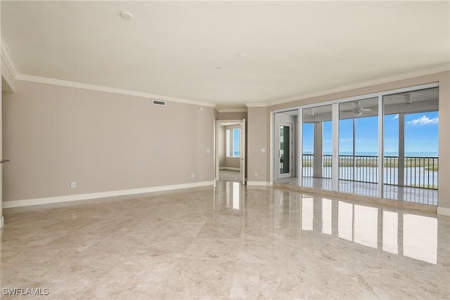 spare room with crown molding and a water view