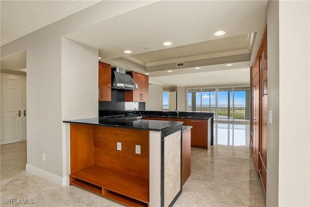 kitchen featuring sink, wall chimney range hood, crown molding, and kitchen peninsula