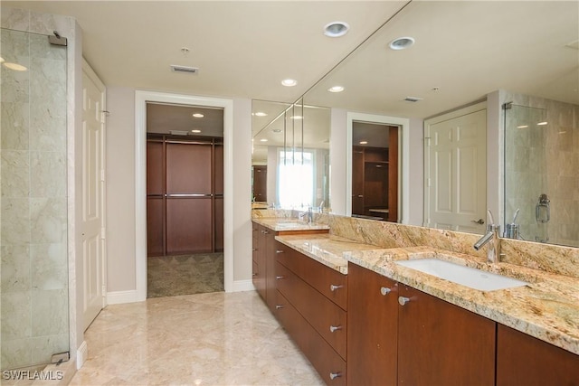 bathroom featuring an enclosed shower and vanity