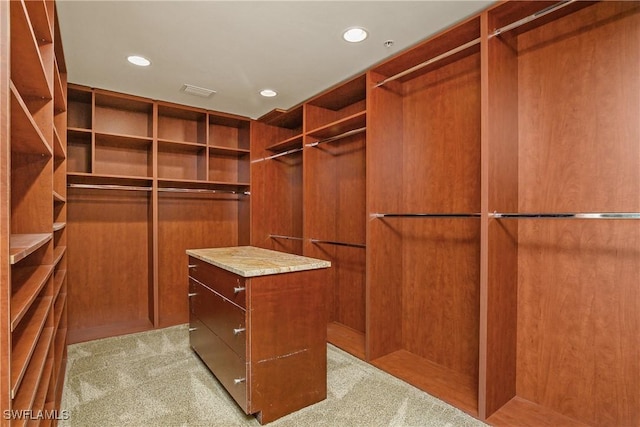 walk in closet featuring light colored carpet