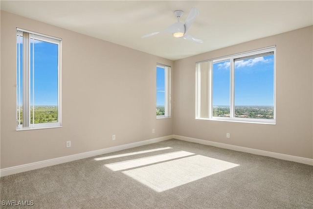 spare room with ceiling fan and carpet flooring