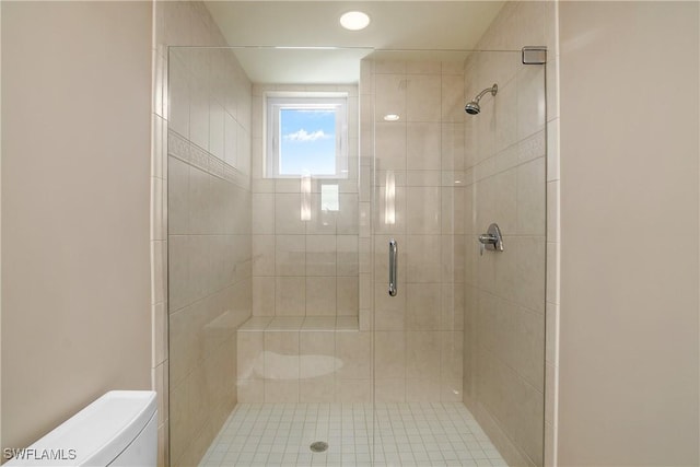 bathroom with an enclosed shower and toilet