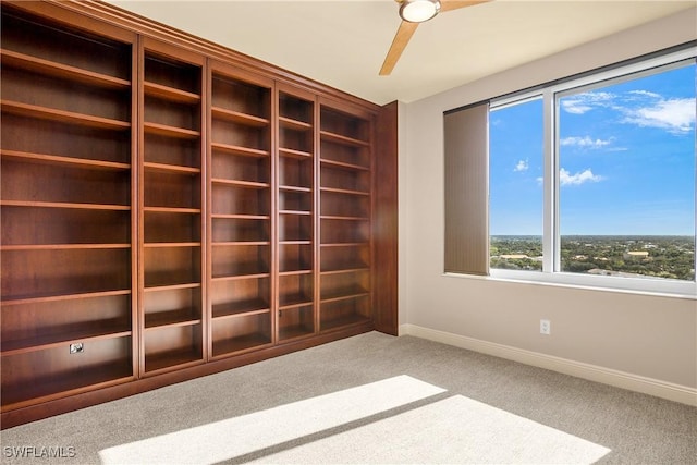 unfurnished room with ceiling fan and light carpet