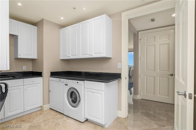 washroom featuring cabinets and independent washer and dryer