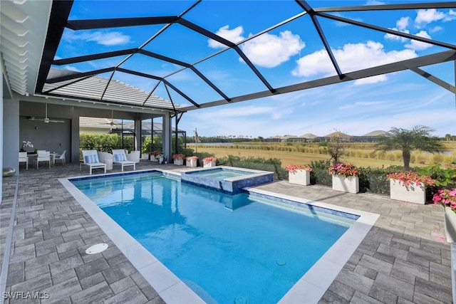 view of pool featuring a lanai, a patio area, a mountain view, and an in ground hot tub