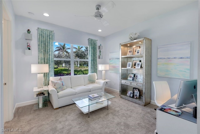 carpeted living room with ceiling fan