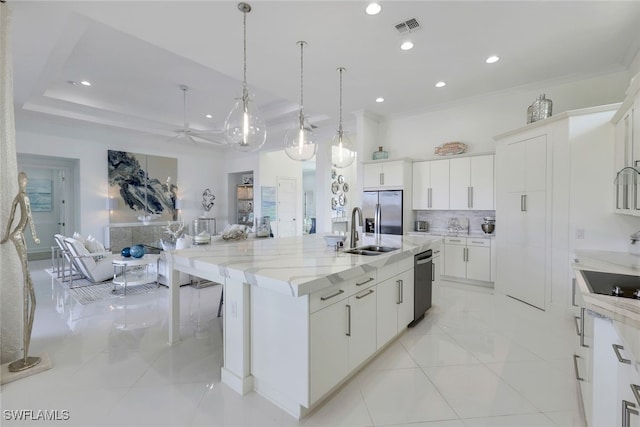 kitchen with stainless steel refrigerator with ice dispenser, black dishwasher, a spacious island, decorative light fixtures, and white cabinets