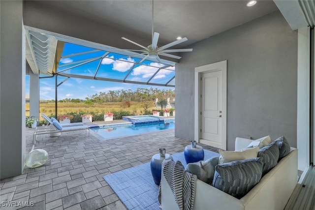 view of patio / terrace featuring a lanai, an outdoor living space, an in ground hot tub, and ceiling fan