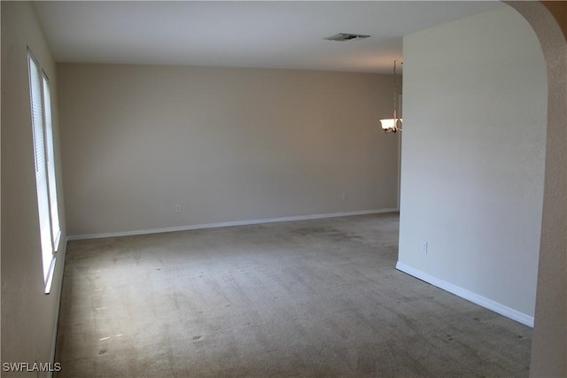 unfurnished room with a wealth of natural light and carpet floors