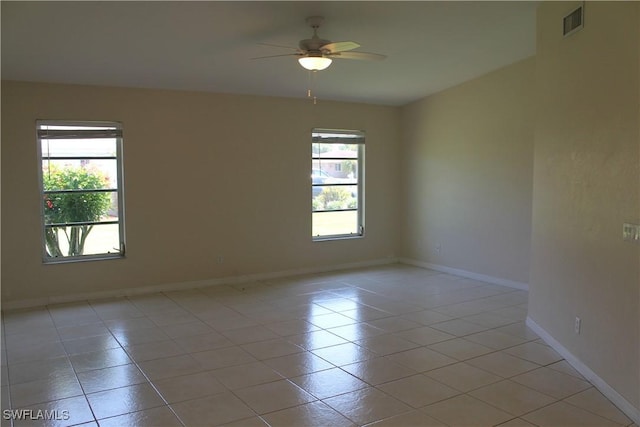 tiled empty room with ceiling fan