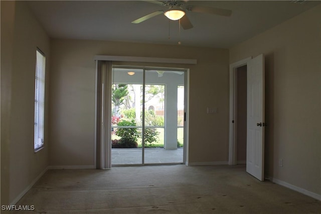 interior space with light colored carpet and ceiling fan