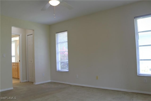 unfurnished room with ceiling fan and light colored carpet