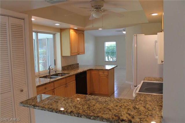 kitchen with range, light stone countertops, kitchen peninsula, sink, and black dishwasher