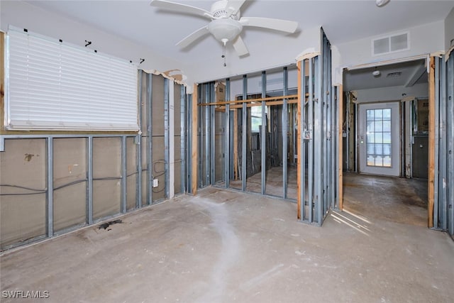 miscellaneous room with ceiling fan and concrete floors